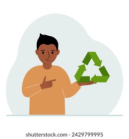 A little boy is holding a green recycle, recycling or ecology sign in his hands.