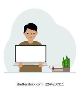 A little boy is holding a laptop in his hands. The concept of online learning, stay at home, home education.