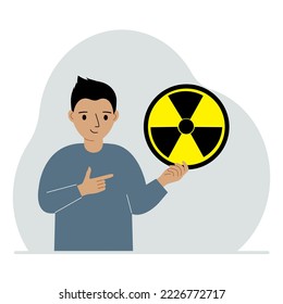 A little boy holds a sign with a warning about nuclear danger. The concept of nuclear war, radiation, biohazard. Vector flat illustration