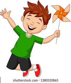 Little boy jumping with a paper windmill 