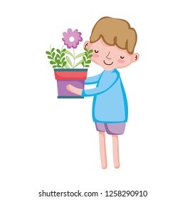 little boy lifting houseplant