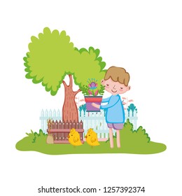 little boy lifting houseplant with fence and chick