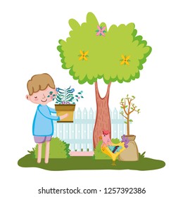 little boy lifting houseplant with fence and rooster