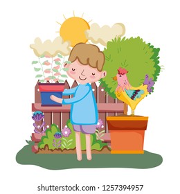 little boy lifting houseplant with fence and rooster
