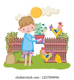 little boy lifting houseplant with fence and rooster