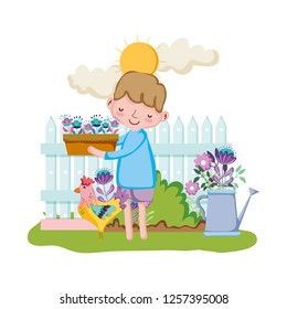 little boy lifting houseplant with fence and rooster