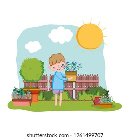 little boy lifting houseplant with fence and tree