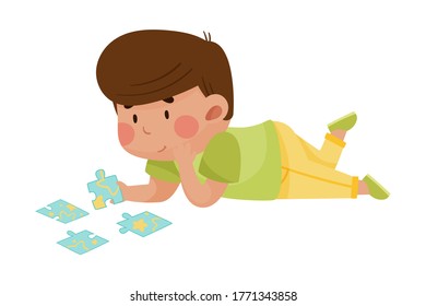 Little Boy Lying and Putting Together Jigsaw Puzzle Vector Illustration