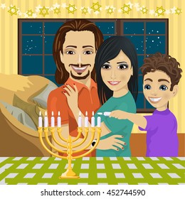 Little boy with mother and father lighting Hanukkah menorah