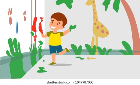 little boy painting the wall using his hand