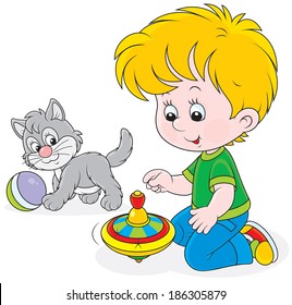 Little boy playing with a grey kitten and a humming-top