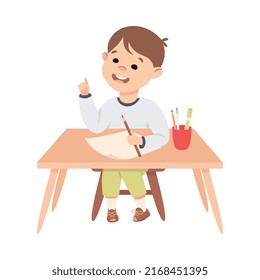 Little Boy Pupil Sitting at Table with Paper and Pencil Engaged in Elementary Education Vector Illustration