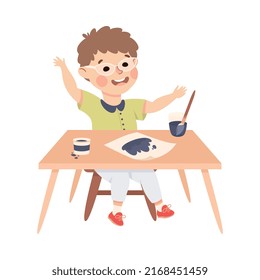 Little Boy Pupil Sitting at Table with Paint Brush Engaged in Elementary Education Vector Illustration