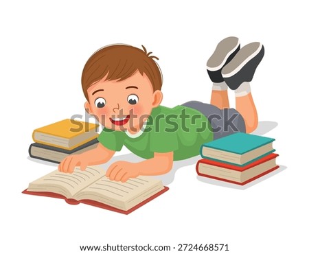 Little boy reading book lying on the floor