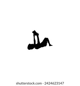 The little boy is reading a book. People enjoy summer. Little boy reading book sitting on the beach, tourist, island, travel, palm tree, rest. Silhouette little boy sitting on the beach