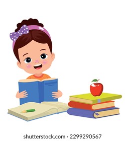 Little boy reading a book with a red apple on the table