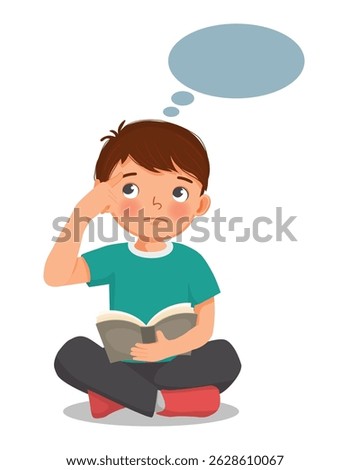 Little boy reading book thinking day dreaming sitting on floor