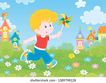 Little boy running and playing with his toy whirligig among flowers on green grass against a background of colorful houses of a small town on a sunny summer day, vector illustration in a cartoon style