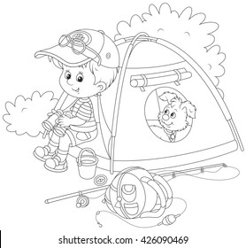 Little boy scout and his pup resting in their camping tent