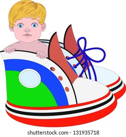 A little boy sits inside the sneakers on blue and yellow background