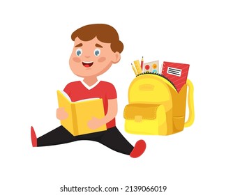  Little boy sits next to his school bag with school equipment and reads a book. Vector  illustration