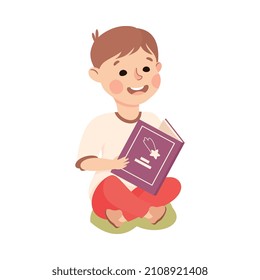 Little Boy Sitting on Green Lawn and Reading Book Vector Illustration