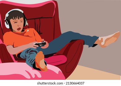 little boy sitting on sofa playing video game at home. Addiction kids of game with emotional expression concept