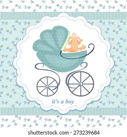 A little boy in a stroller on an abstract background in child blue flowers. Blue stroller with the baby.