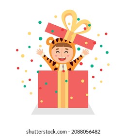 Little boy in a tiger costume jumps out of a gift box