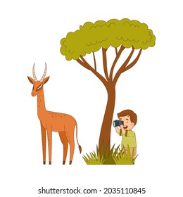 Little Boy Traveler Visiting Tropical National Park Sitting in Bush with Camera Taking Photo of Antelope Vector Illustration