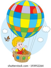 Little boy travelling with his pup on a colorful air balloon