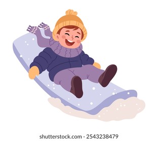 A little boy in warm clothes    sledding down a hill