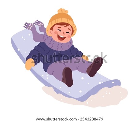 A little boy in warm clothes    sledding down a hill