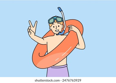 Little boy who loves to swim in pool with inflatable ring shows V gesture and looks at screen with smile. Teenage child comes to water park to swim and greets friends, anticipating fun.