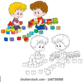 Little boys play with a toy train and bricks