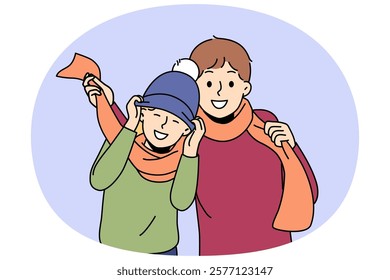 Little boys in winter hats and scarves rejoicing at onset of winter and preparing for walk in park. Boys brothers or friends having fun enjoying communication and coming of december holidays