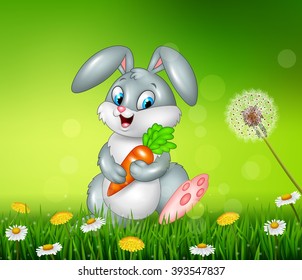 Little bunny holding carrot on grass background