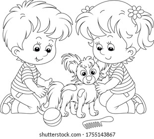 Little children brushing their cheerful small Papillon puppy for a walk, black and white outline vector cartoon illustration for a coloring book page