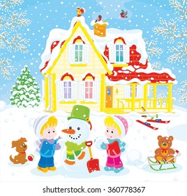 Little children making a funny snowman before their house