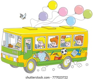 Little children riding a school bus with stickers and balloons