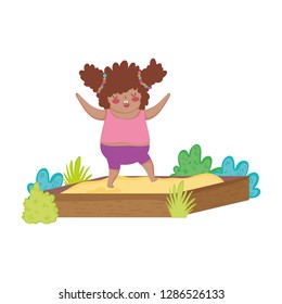 Little chubby girl playing in sand box