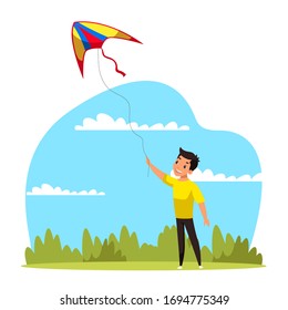 Little cute boy flying kite into blue sky. Schoolchild have fun in green park on summer holiday. Happy child play with toy in yard. Outdoor recreation and activity. Childhood leisure during summertime