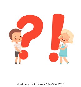 Little cute boy and girl hold question and and exclamation marks. A concept for children's questions and answers. Curious children