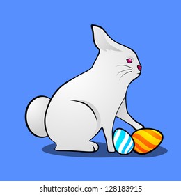 Little cute Easter rabbit with painted eggs on blue background.