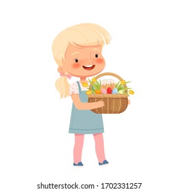 Little cute girl carries a basket with colored eggs, tulips and Easter cake for the Easter holiday. Spring holiday Easter.