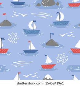 Little cute ships with white sails on a blue background. Children's seamless patern