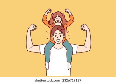 Little daughter sits on shoulders of strong father and demonstrates biceps, wanting to become like dad. Preteen girl together with father or older brother for generational succession concept