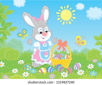 Little Easter bunny with a decorated basket and colorfully painted eggs among flowers, vector illustration in a cartoon style