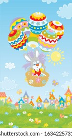 Little Easter bunny flying in its holiday basket with colorfully decorated balloons above a small toy town on a sunny spring day, vector cartoon illustration