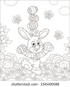 Little Easter bunny juggling with colored eggs among flowers on grass of a lawn on a sunny spring day, black and white vector illustration in a cartoon style for a coloring book